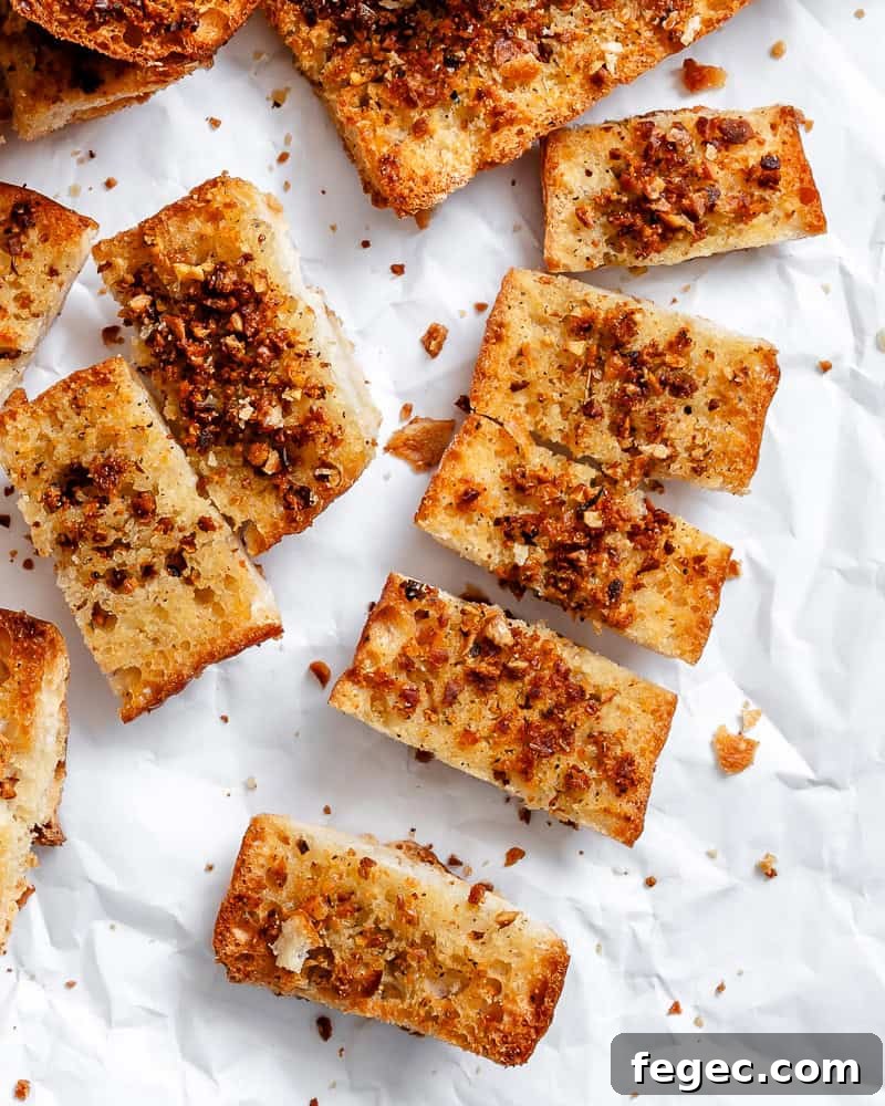 Crispy Vegan Garlic Bread Recipe You’ll Love 10 several Easy Vegan Garlic Bread pieces on white surface
