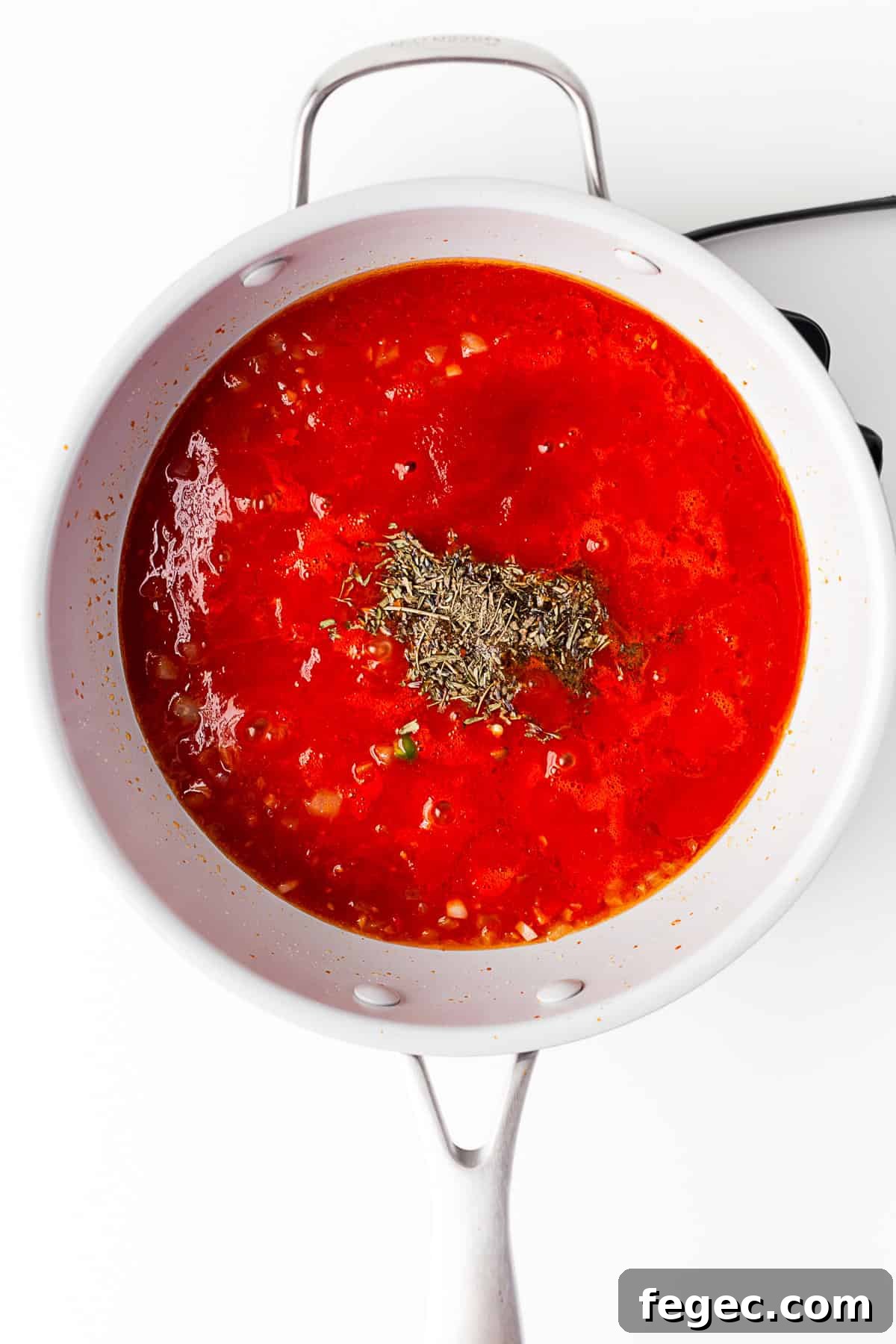 A pan of simmering tomato sauce.
