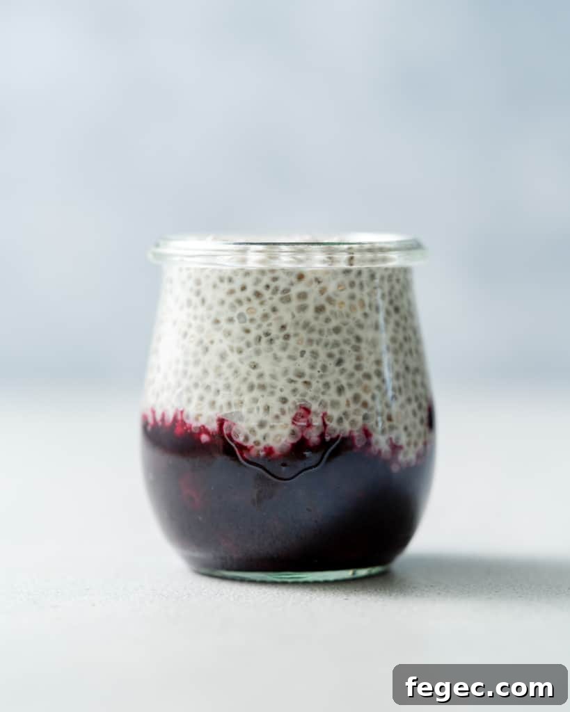 Layering chia pudding over blueberry sauce.