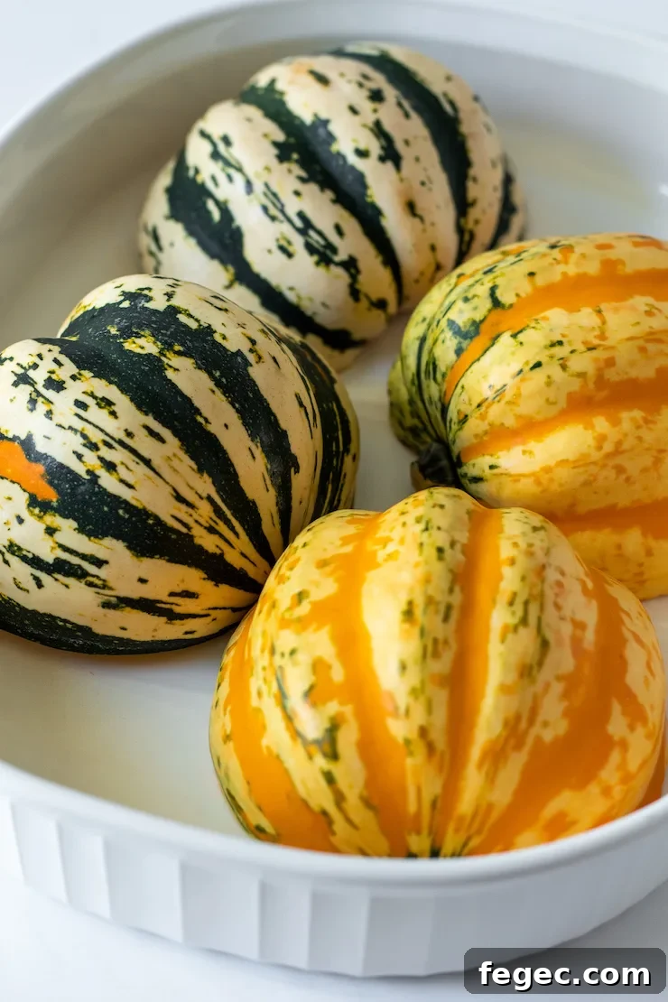 Herbed Turkey Stuffed Acorn Squash Recipe for Fall Dinner 5 Carnival squash variety cut side down in baking dish.