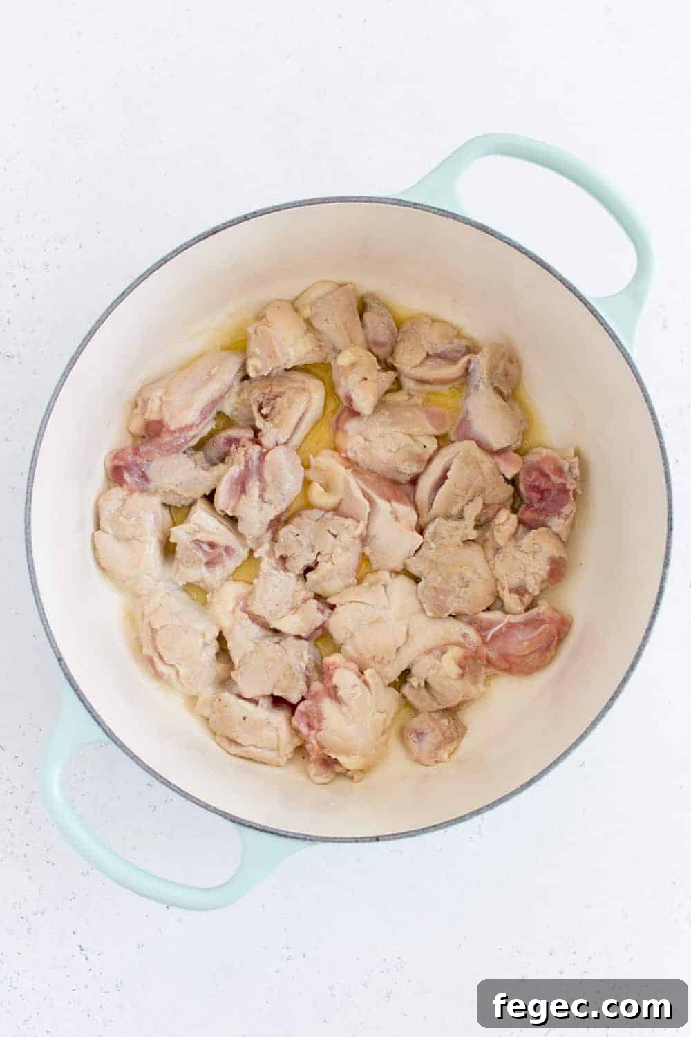 chicken thighs browning in dutch oven