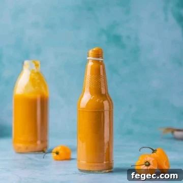 Sweet and Spicy Mango Habanero Sauce for wings in a bottle on a flat surface.