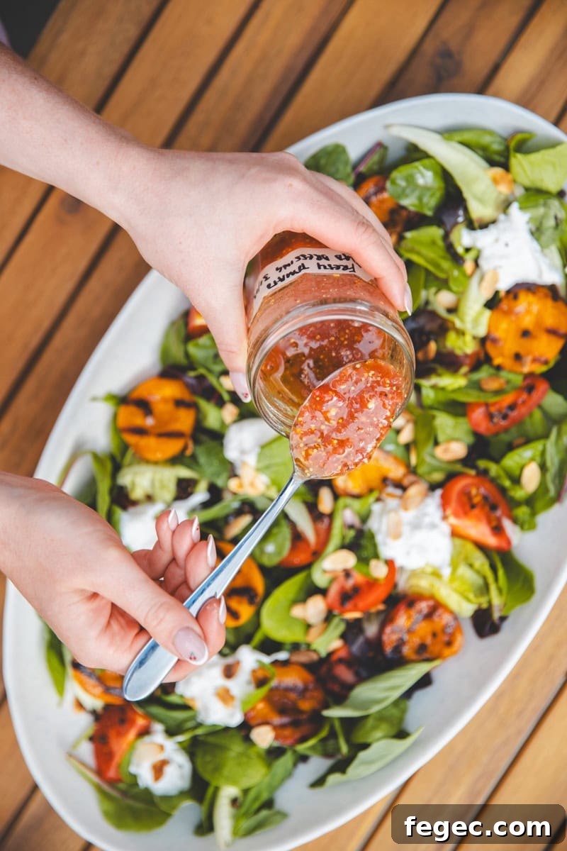 Pouring dressing on Griddled Apricot Salad - Georgie Eats
