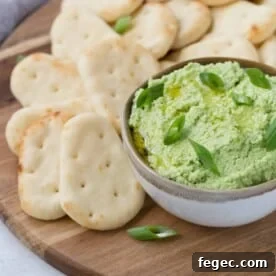 Bright green edamame dip topped with green onions.