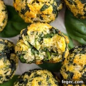 Spinach balls, one with a bite taken out of it.