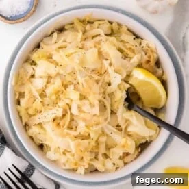 Sautéed cabbage in a bowl with a spoon.