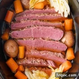 Slow cooker corned beef with carrots, potatoes, cabbage.