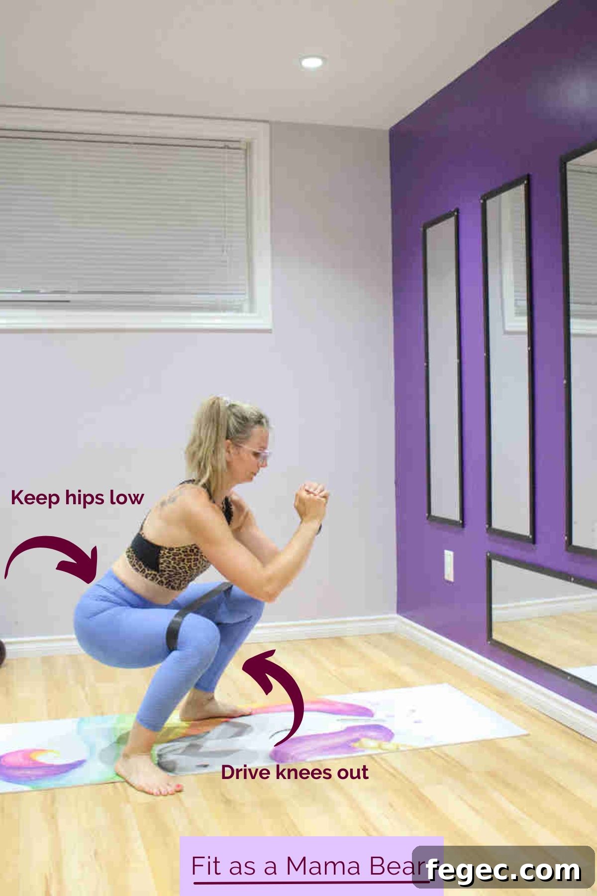 Low-Impact Body Blast: Total-Body Fat-Burning Workout 4 A woman in blue pants and a sports bra performing a squat with a mini band