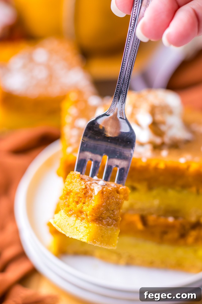 Bite of pumpkin gooey butter cake on a fork.