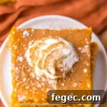 Overhead image of ooey gooey butter cake on a white plate.