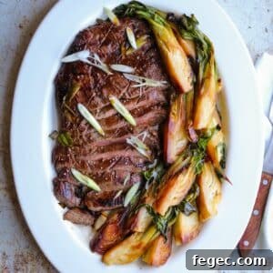 Asian-Marinated Grilled Flank Steak Recipe 9 Asian marinated grilled flank steak on white platter