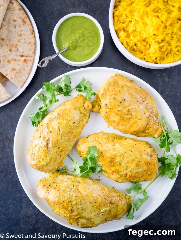 Yogurt marinated chicken breasts served with turmeric-infused basmati rice and cilantro sauce. Yogurt marinated chicken breasts served with rice and cilantro sauce.