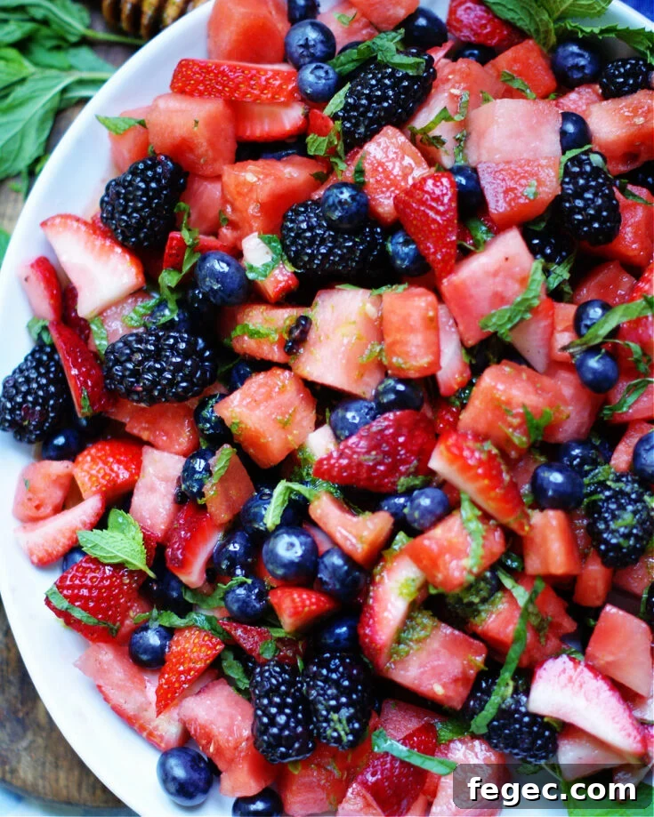 chunks of watermelon, strawberries, blueberries, blackberries, mint and a honey lime dressing to serve as a side dish or dessert.