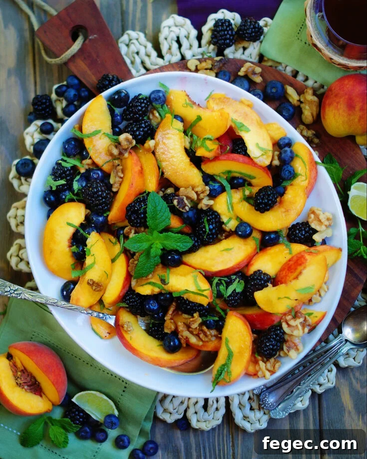 Sliced peaches, blackberries, blueberries, walnuts, mint and a honey lime dressing.