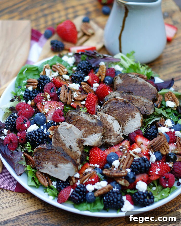 Berry Salad with balsamic dressing drizzled all around and peppered pork tenderloin.