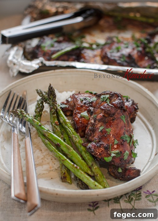 Soy Balsamic glazed chicken thighs served with rice and asparagus.