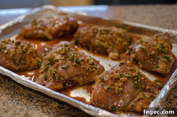 Balsamic soy sauce marinated chicken thighs on a baking sheet.