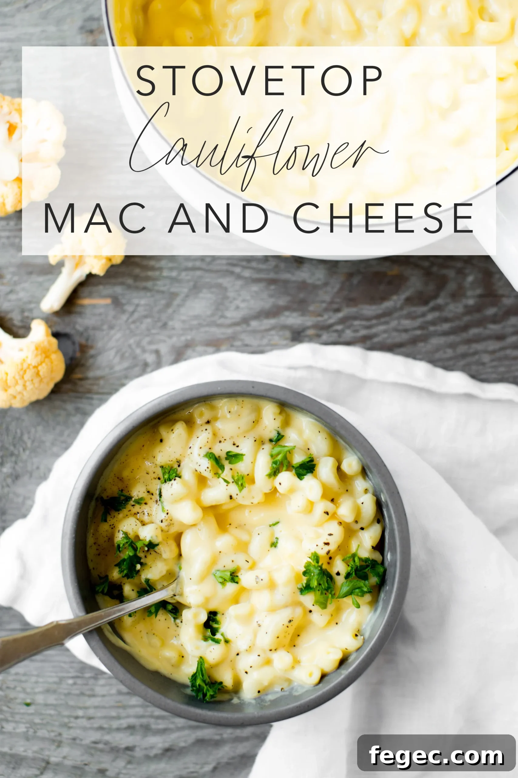 stovetop cauliflower mac and cheese in a bowl with a gray background and text overlay