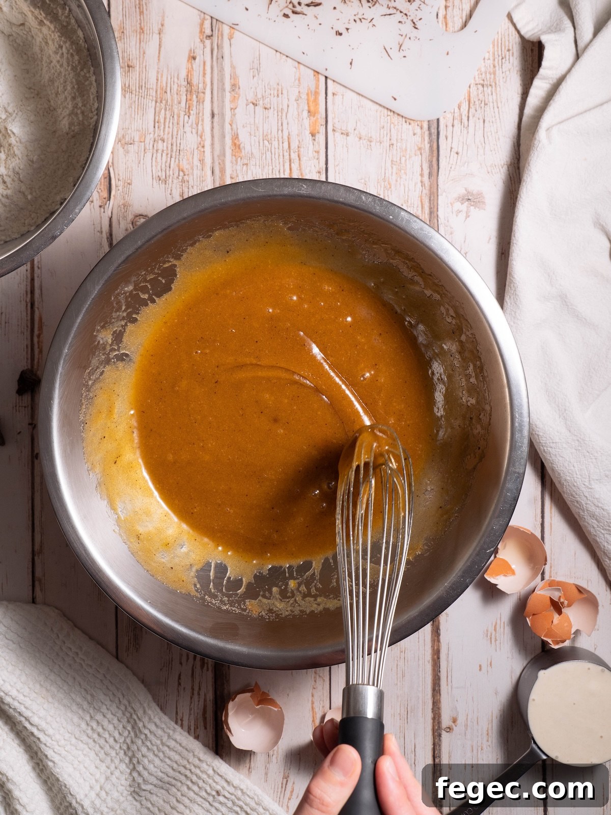 Brown sugar and butter being whisked to ribbon stage
