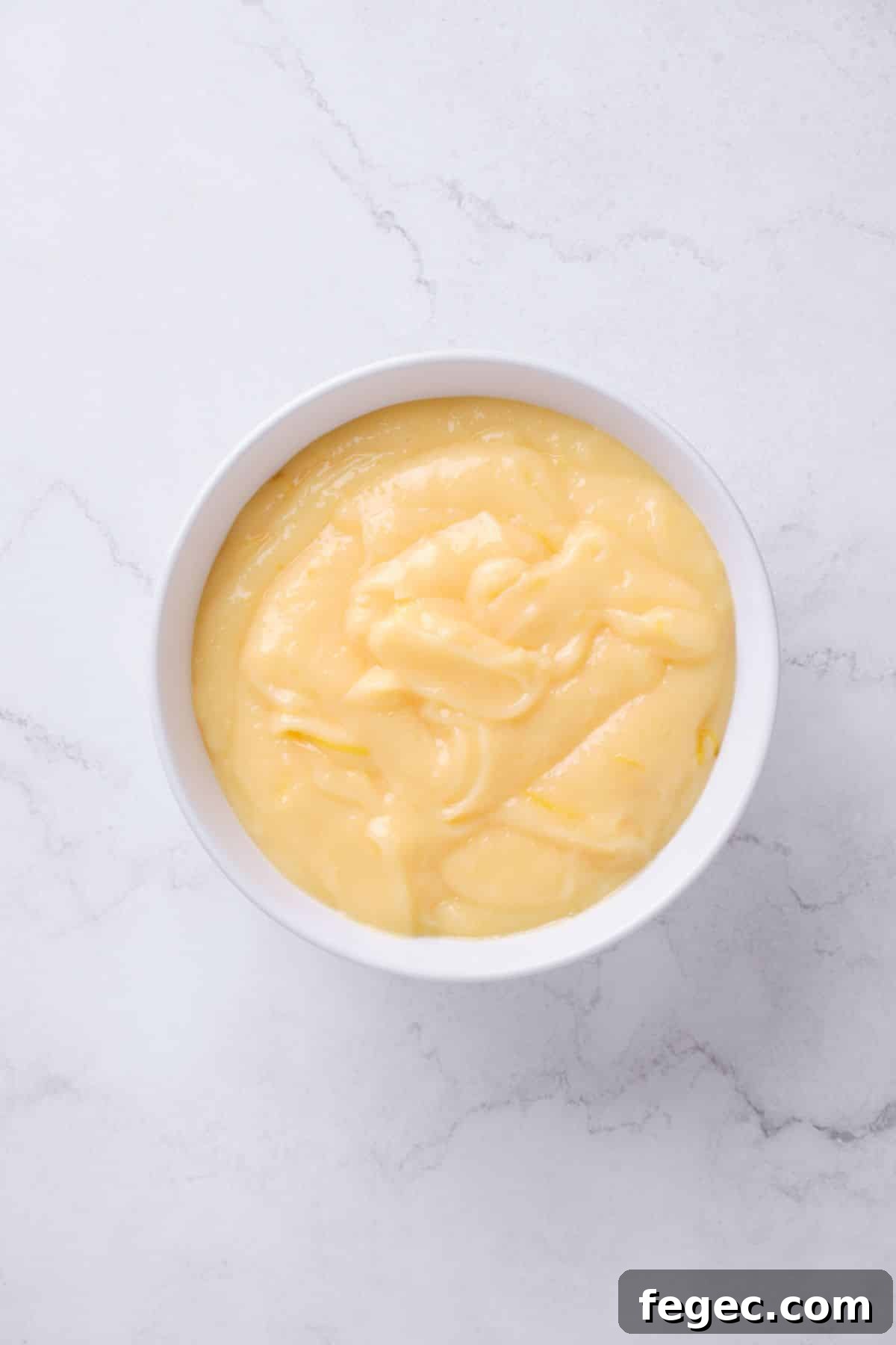 A bowl of homemade lemon curd filling.