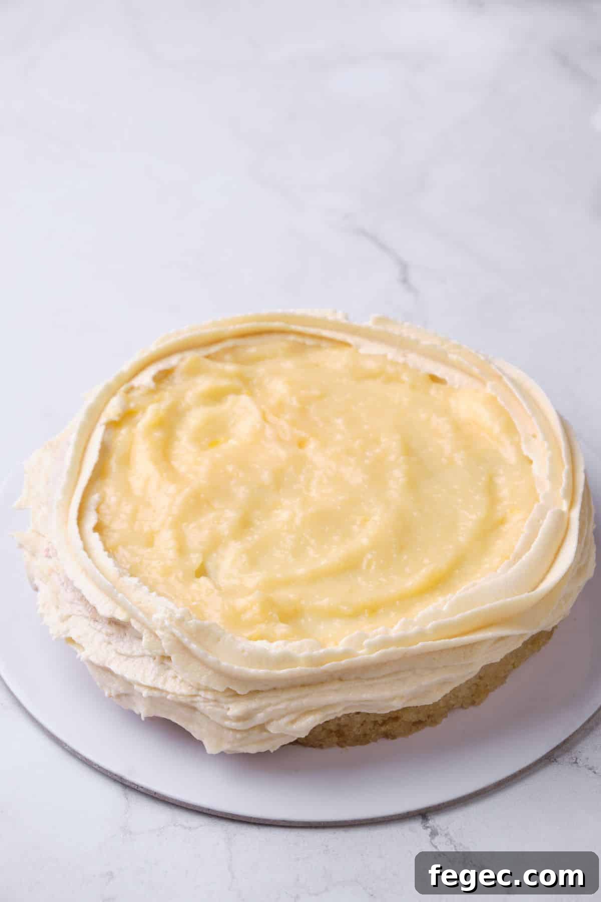 Lemon curd filling on top of a cake layer.