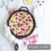 Raspberry Buttermilk Clafoutis topped with fresh raspberries and lemon sugar served with rich crème fraîche.
