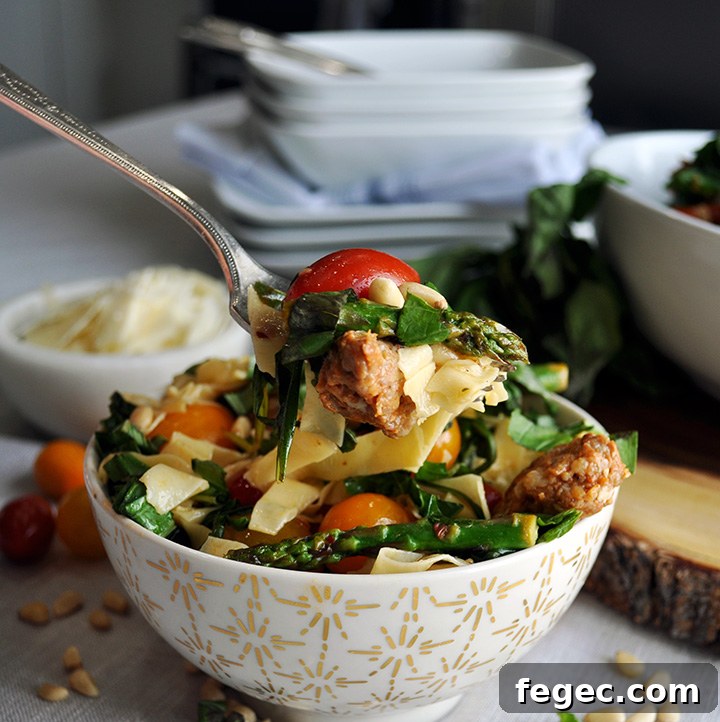 Eating pasta with sausage and vegetables.