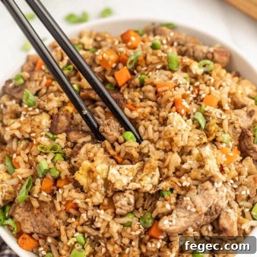 Chinese fried rice in a bowl with chopsticks.