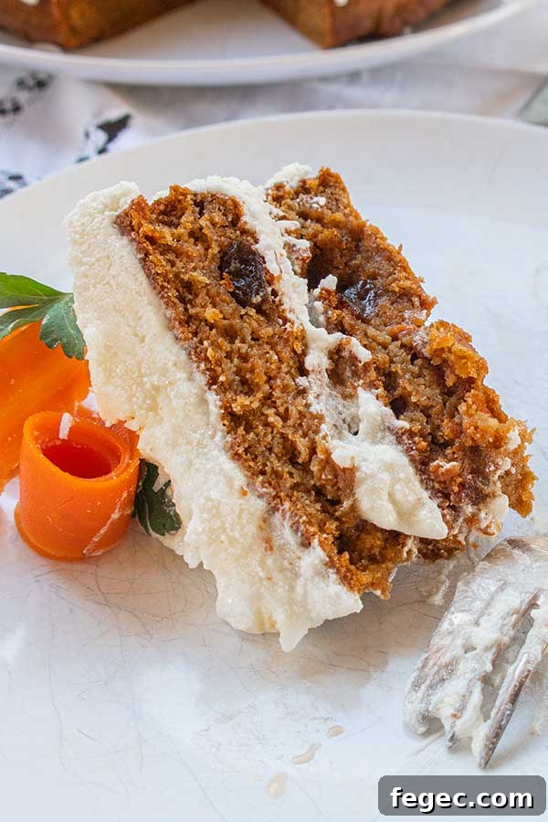 side view of a slice of gluten free cake with frosting on a plate