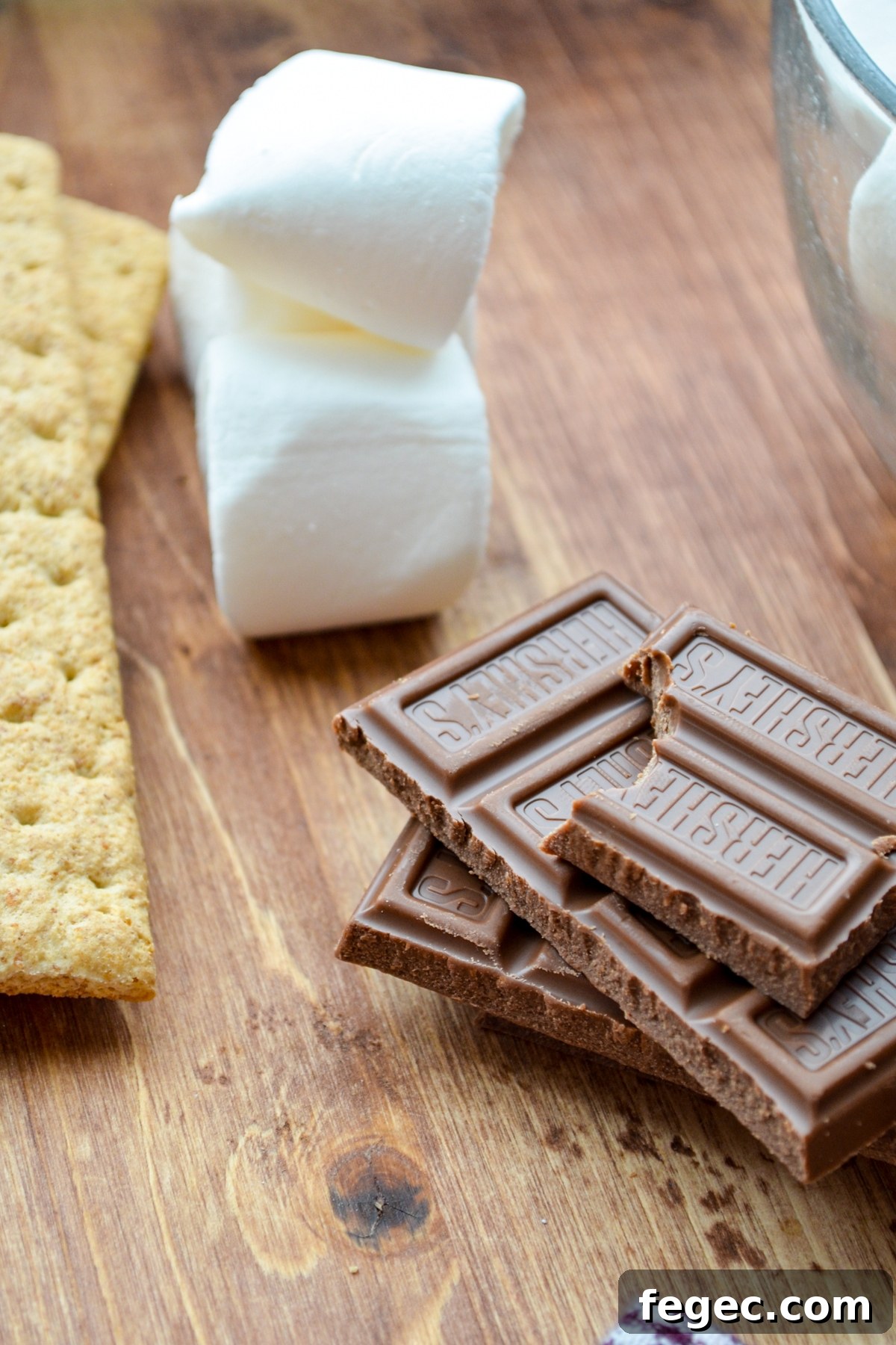 A few bars of chocolate, some marshmallows, and some graham crackers.