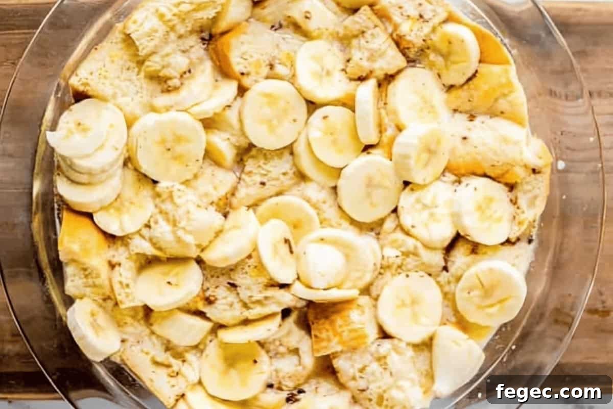 banana bread pudding in a glass bowl before baking.