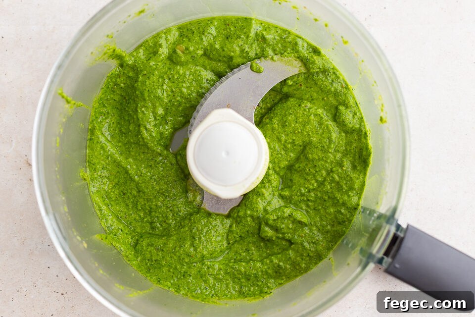 fresh homemade pesto blended up in a food processor base.