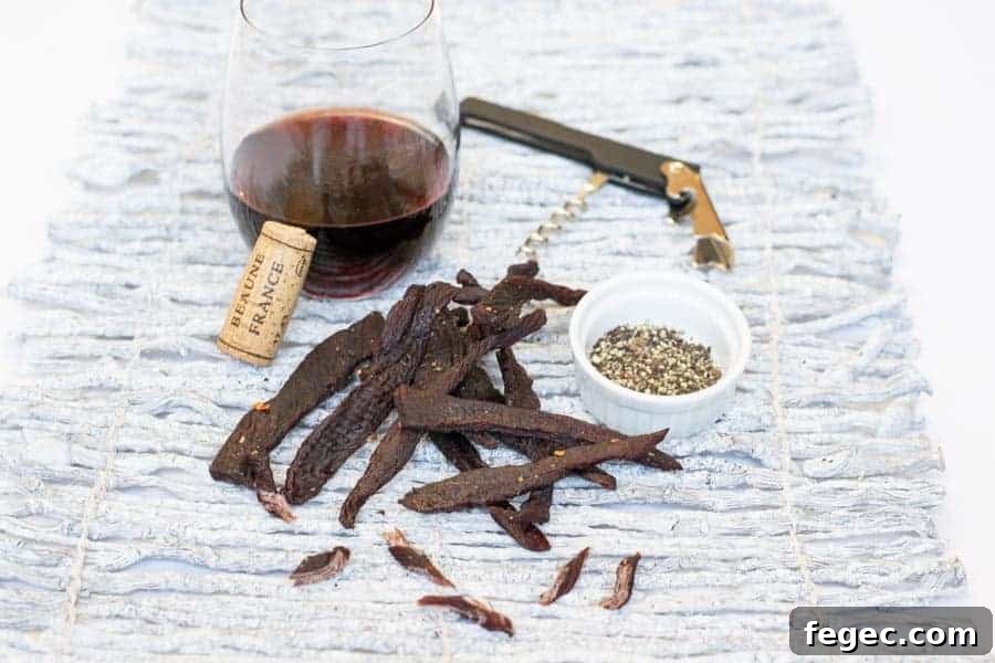 Deer jerky with wine, corkscrew, salt, and pepper