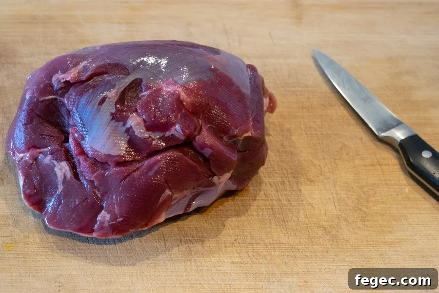 Venison roast on cutting board with knife