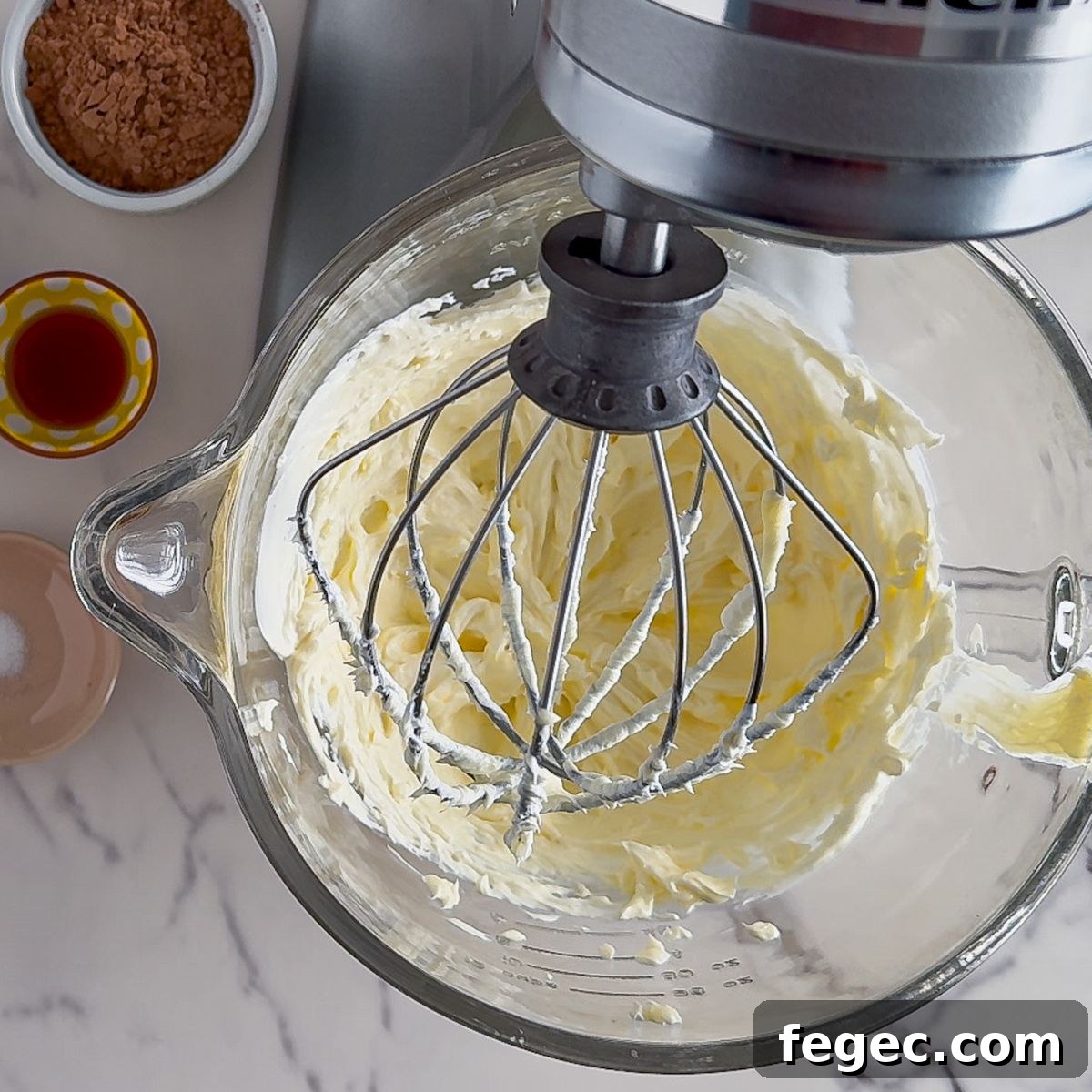 Beating the cream cheese.