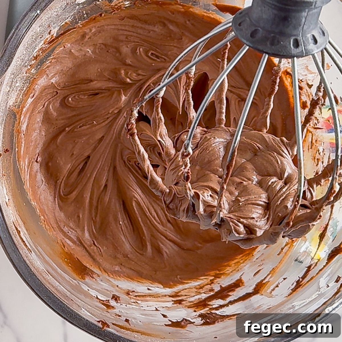 Beating the cream cheese frosting.