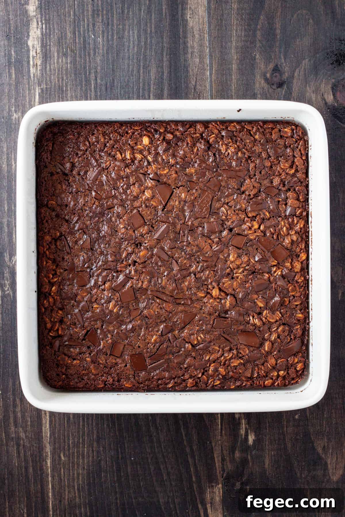 Chocolate baked oatmeal cooked and set in a square baking dish.