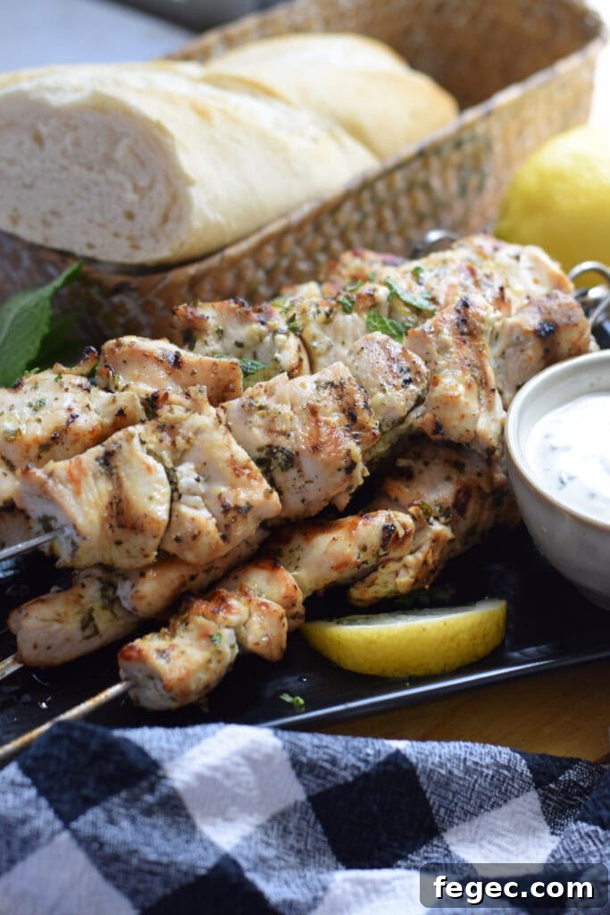 Chicken skewers on a plate with lemon.