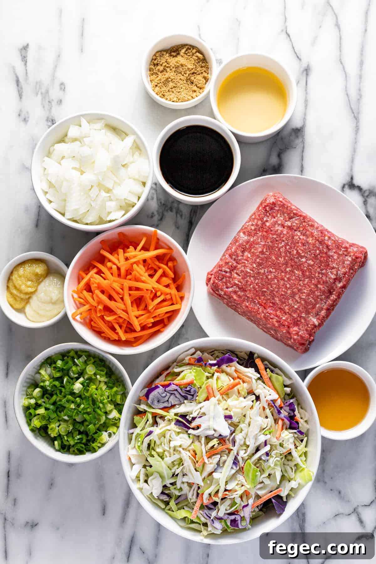 Bowls of ingredients to make egg roll in a bowl.