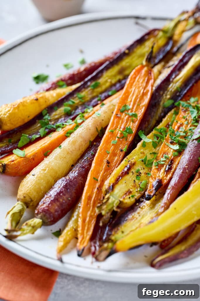 A plate of caramelized rainbow carrots garnished with chopped parsley
