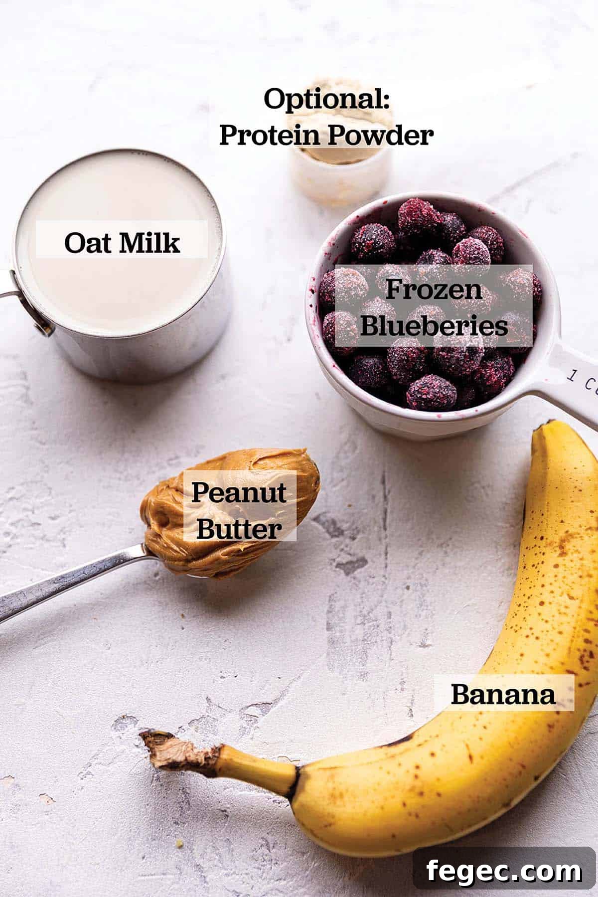 Banana, frozen blueberries, peanut butter, oat milk and protein powder.