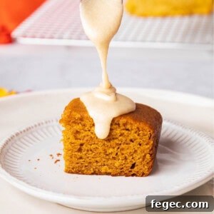 Pouring a spoonful of maple glaze over a pumpkin dessert