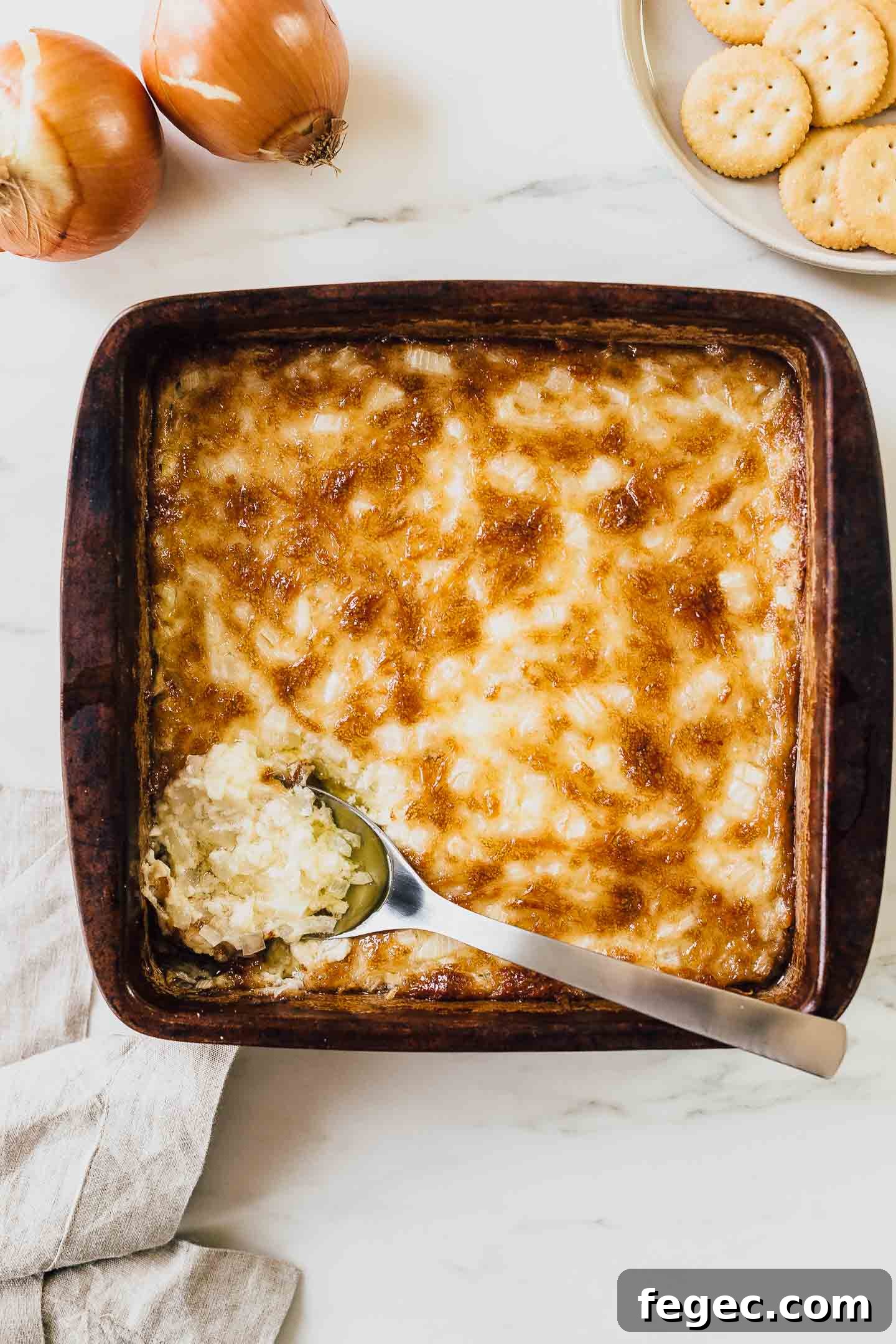 Hot onion dip in baking dish.
